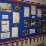 School board with drawings and text and surrounded by union jack flags